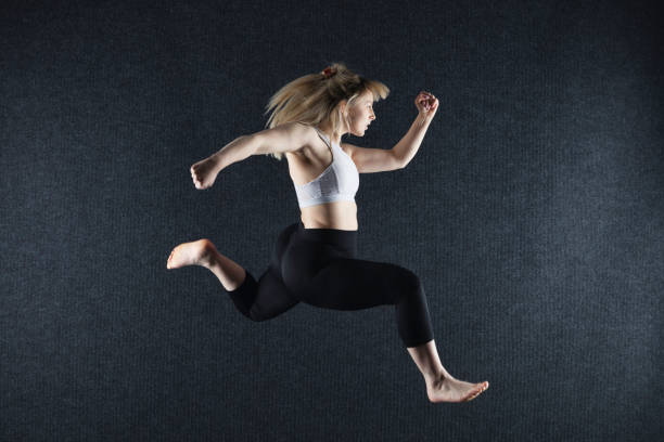 A very athletic dancer photographed in mid-air.