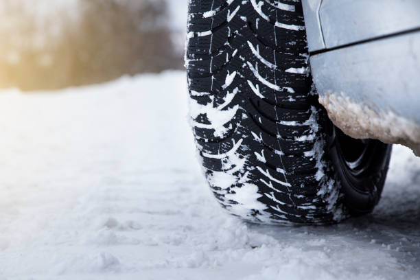 istock Car tires on winter road 1129342250