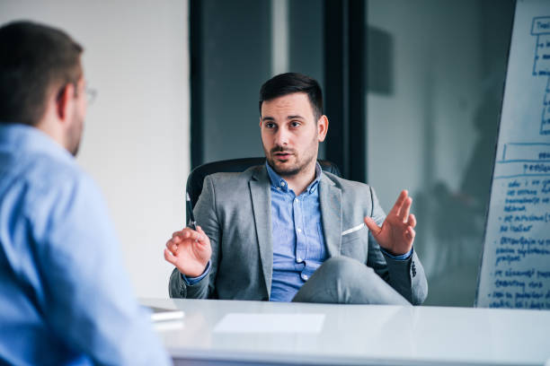 istock Handsome man talking to his employee on a meeting. 1129342448