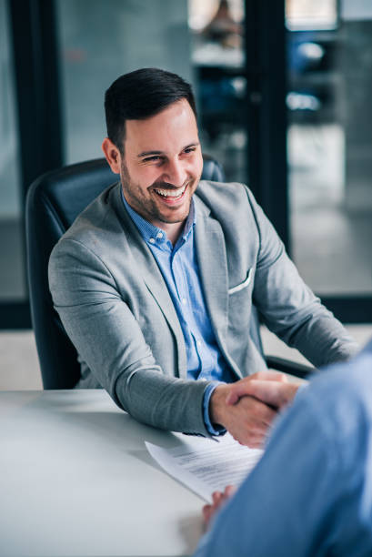 istock Friendly business handshake. Smiling handsome elegant man handshaking with employee. 1129342466