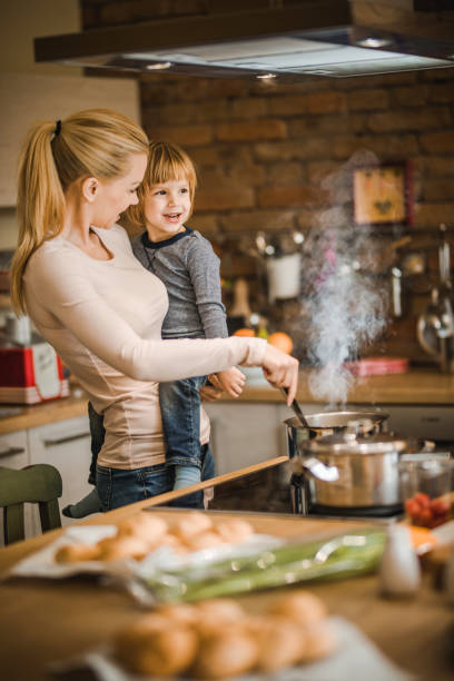 istock Loving mother and son cooking lunch in the kitchen. 1129343574