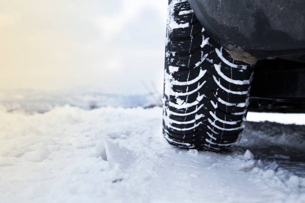 istock Car tires on winter road 1129343622