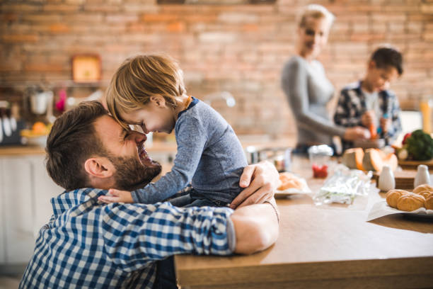 istock Cheerful father having fun with his small son in the kitchen. 1129343681