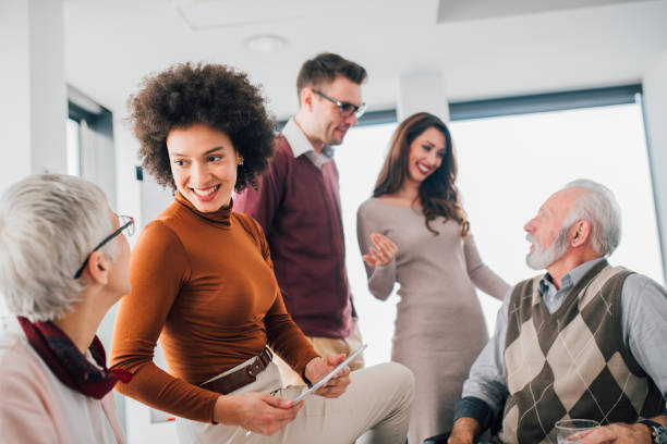 istock Young woman with coworkers 1129343858