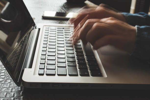 istock Fast typing woman on laptop. Blurred hands typing 1129344976
