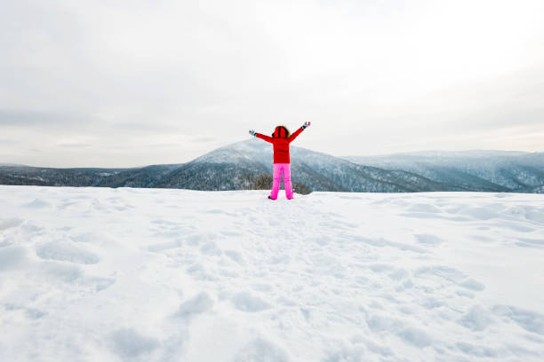istock Woman hiker on mountain top in winter 1129346834