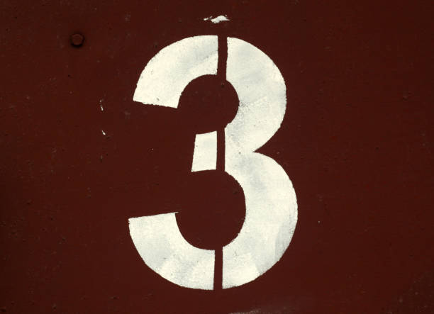 istock Number 3 in stencil on red metal wall 1129348045