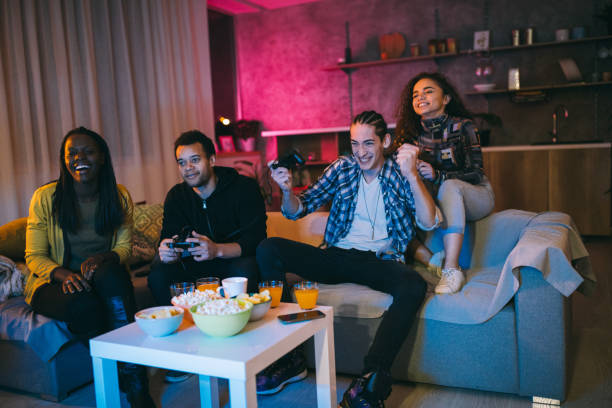 istock Young Man Defeating His friend in Video Games 1129348418