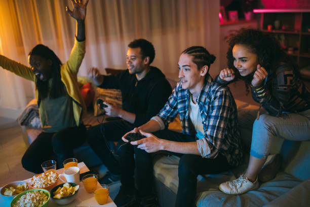istock Young Man Defeating His friend in Video Games 1129348466