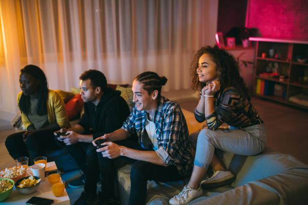 istock Two male friends playing video games 1129348505