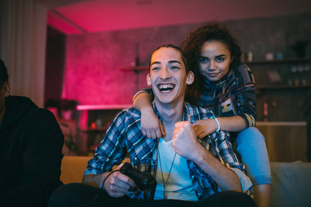 istock Couple celebrating victory in video games 1129348534