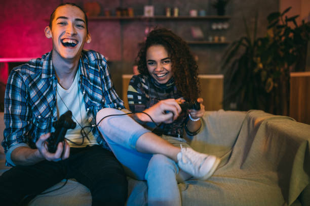 istock Couple having fun while playing video games at home 1129348604