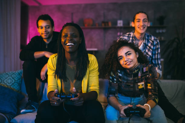 istock Female friends playing video games 1129348846