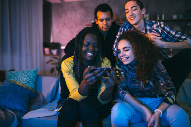 istock Group of friends looking at smart phone and laughing 1129348874