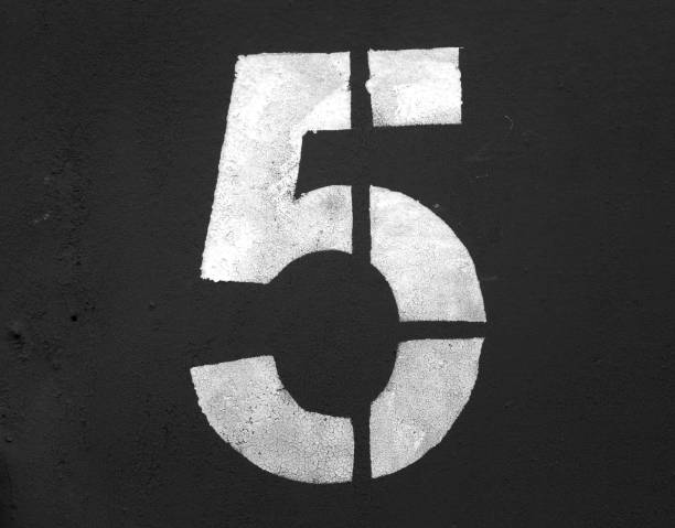 istock Number 5 in stencil on metal wall in black and white. 1129349538