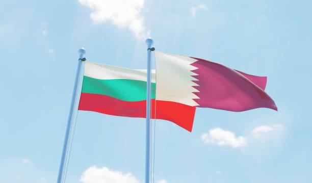 istock Qatar and Bulgaria, two flags waving against blue sky 1129350248
