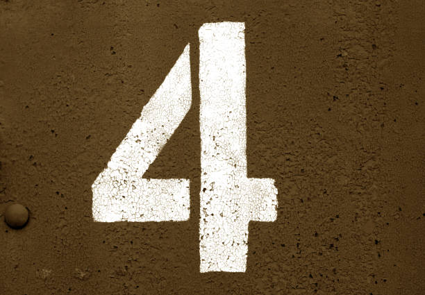 istock Number 4 in stencil on metal wall in brown tone. 1129350644