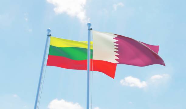istock Qatar and Lithuania, two flags waving against blue sky 1129350682