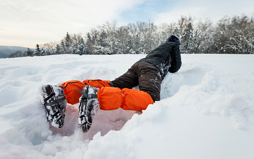 Man falling down on the snow field.