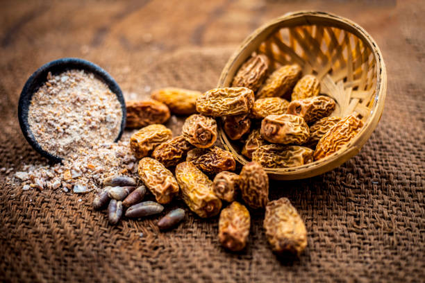 istock Close up dried dates of kharek or Phoenix dactylifera in a fruit basket on brown surface. 1129352237