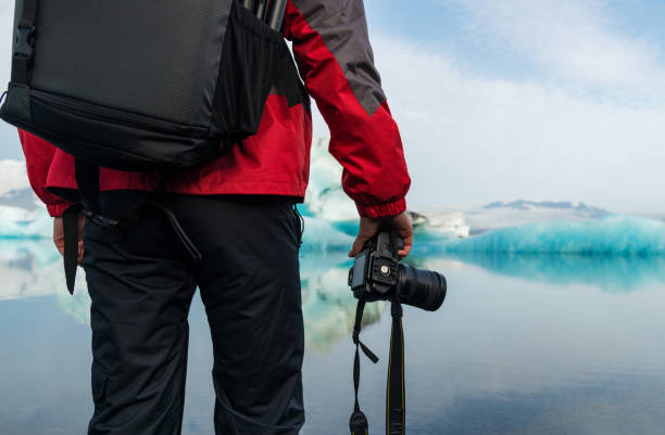 istock Photographer in glacier lagoon in Iceland 1129352435