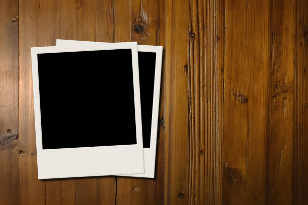 istock Blank frame photos on wood background with copy space 1129352882