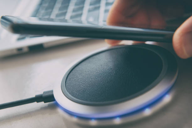 istock Smartphone charging on a wireless charger 1129352958