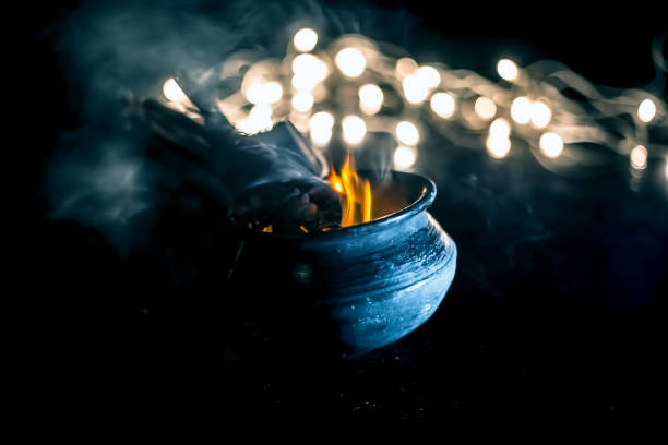 istock Popular and famous ancient method to kill mosquitoes or mosquito repellent. i.e. Burning some sticks of certain trees in a pot.Close up shot with blurred background of lights. 1129355045