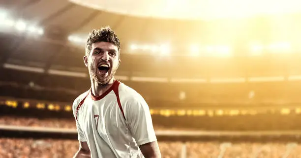 Photo of Happy soccer player on a football stadium