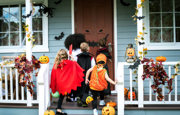 Young kids trick or treating during Halloween Young kids trick or treating during Halloween trick or treat photos stock pictures, royalty-free photos & images
