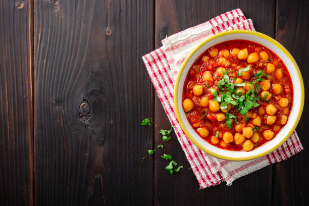 istock Spicy Chickpea curry Chana Masala in bowl on dark wooden table 1129362261