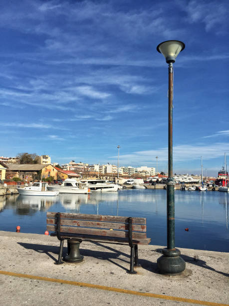 istock an empty bench by sea in Greece 1129365816