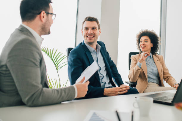 istock Young adults at staff meeting at work 1129365882