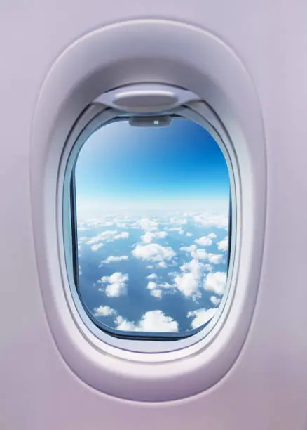 Airplane interior with window view of clouds. Concept of travel and air transportation
