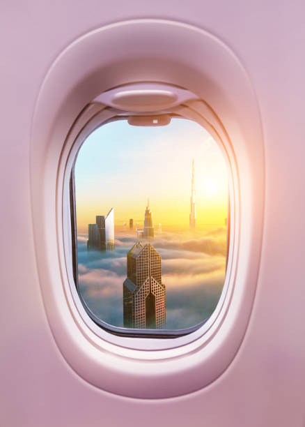 istock Airplane interior with window view of Dubai city 1129366860