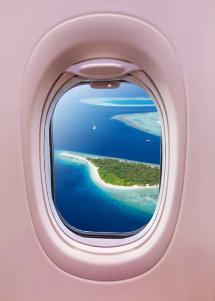istock Airplane window view of Maldives islands 1129366911