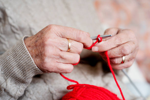 istock old caucasian woman knitting 1129368682