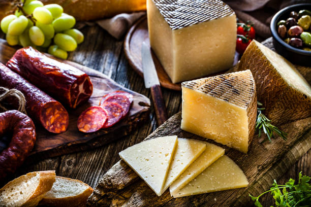 istock Spanish food: Manchego cheese, spanish chorizo and olives on rustic wooden table 1129369462