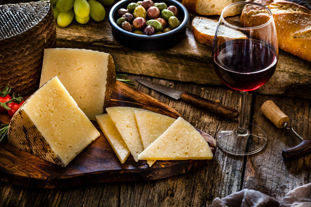 istock Spanish food: Manchego cheese and red wine on rustic wooden table 1129369488