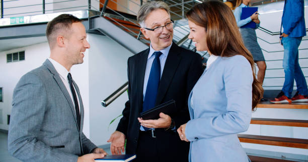 istock Smiling business people chatting in the lobby 1129369685