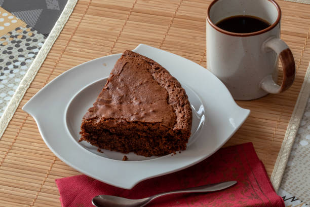 istock Slice of chocolate cake covered with custard 1129369905