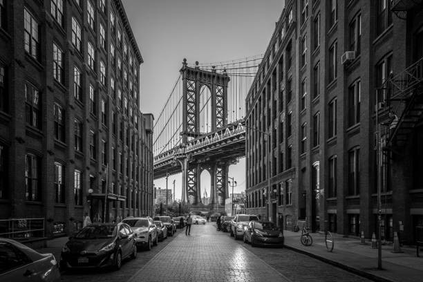 Manhattan Bridge in New York City New York, United States of America - November 18, 2016: Pillar of Manhattan Bridge as seen from an alley in Dumbo district in Brooklyn dumbo new york photos stock pictures, royalty-free photos & images