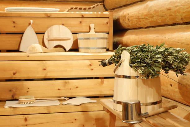 Dry birch broom in the sauna. Dry birch broom on the wooden bucket and bath accessories in the sauna. красота stock pictures, royalty-free photos & images
