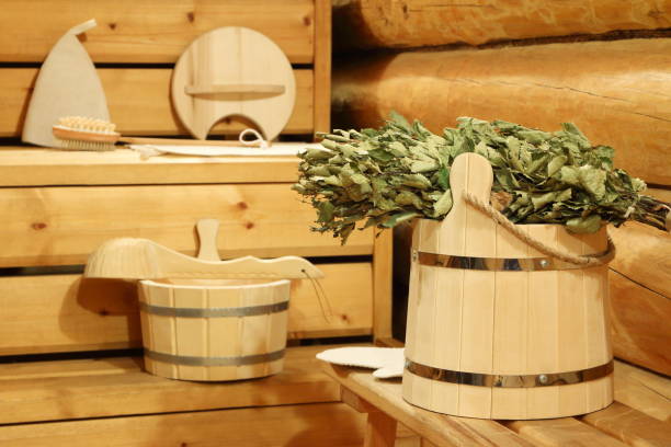 Dry birch broom in the sauna. Dry birch broom on the wooden bucket and bath accessories in the sauna. интерьер помещений stock pictures, royalty-free photos & images