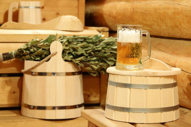 A mug of  light beer in the sauna. A mug of  light beer on a barrel in the interior of sauna on the background of bath accessories. интерьер помещений stock pictures, royalty-free photos & images