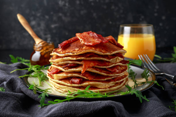 istock Pancakes with crispy bacon and maple syrup in a plate. Morning Breakfast 1129372782