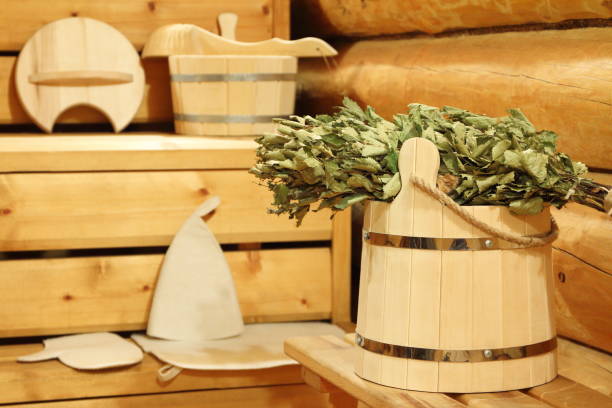 Dry birch broom in the sauna. Dry birch broom on the wooden bucket and bath accessories in the sauna. интерьер помещений stock pictures, royalty-free photos & images