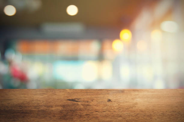 istock empty wood table on blur coffee shop background 1129373127