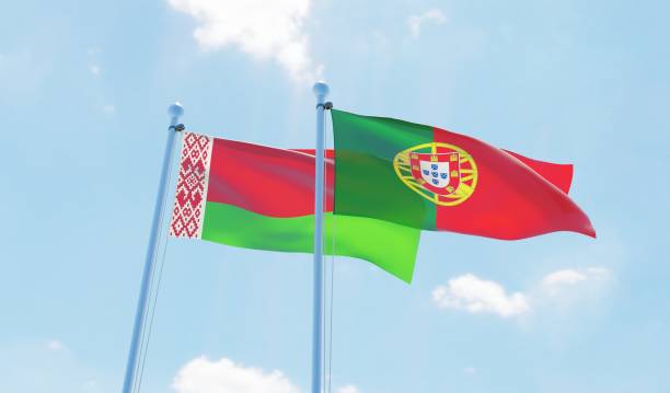istock Portugal and Belarus, two flags waving against blue sky 1129374351