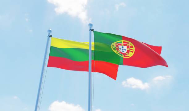 istock Portugal and Lithuania, two flags waving against blue sky 1129374602